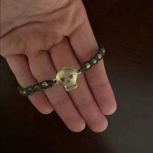 Gold and brown string skull bracelet